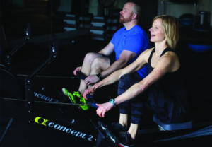 trainers working out on rowing machine